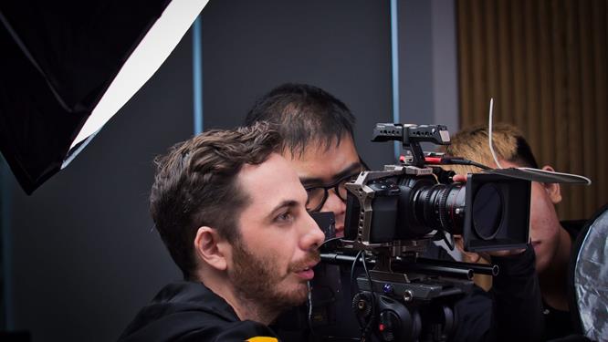 A Saigon Videographer operator filming with a cinema camera and lighting rig.
