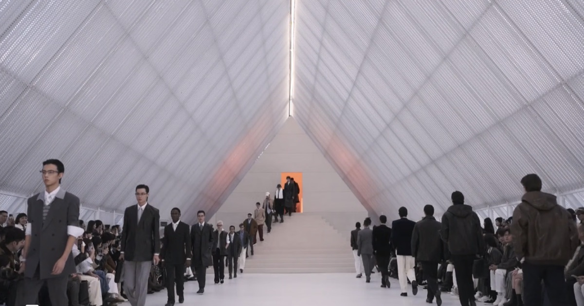 A TRUC Studio runway show production, guests seated along a lit tunnel walkway.